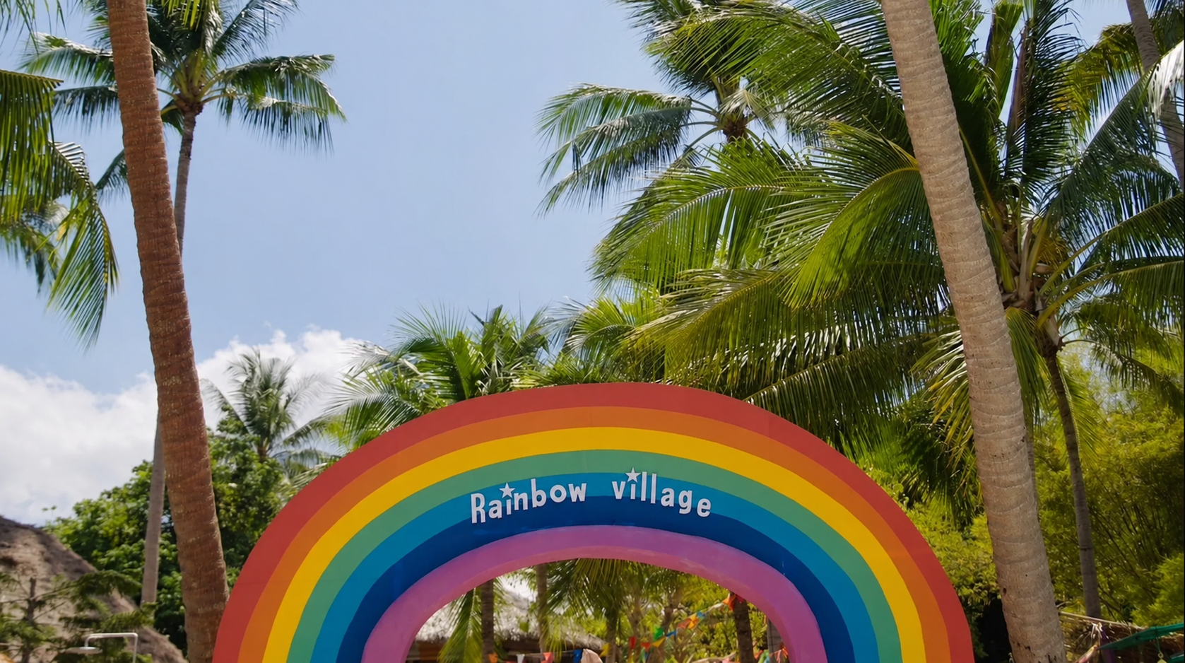 Rainbow Village arch entrance with palm trees